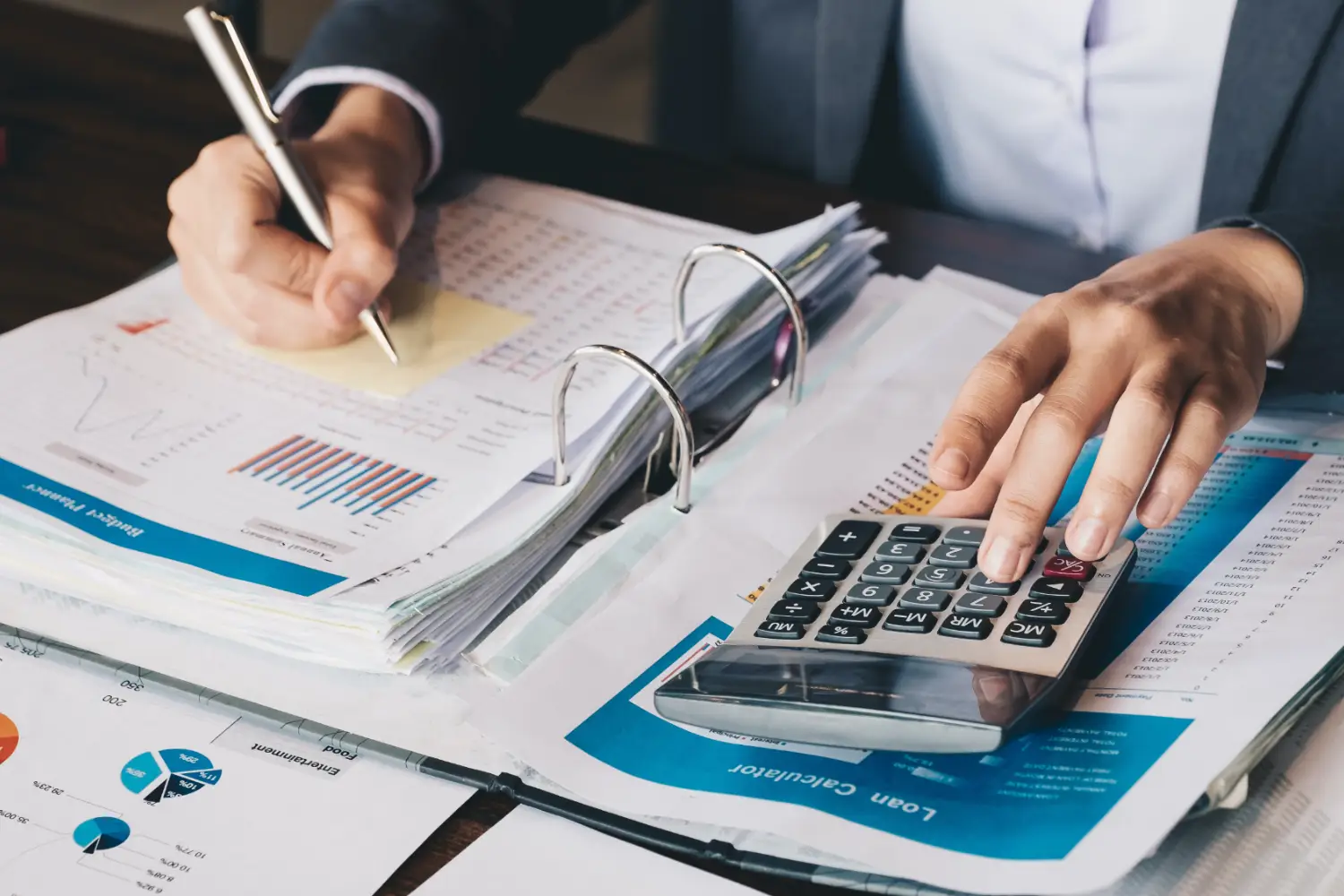 A person using a calculator to help plan business taxes